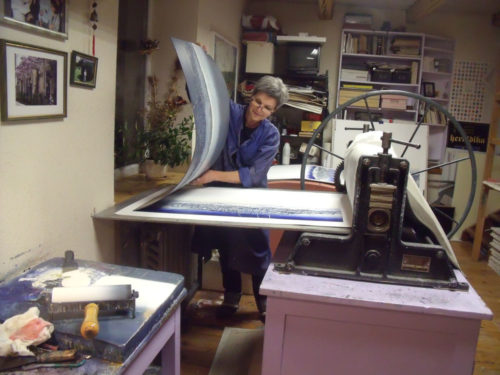 Daliute making a print in her studio