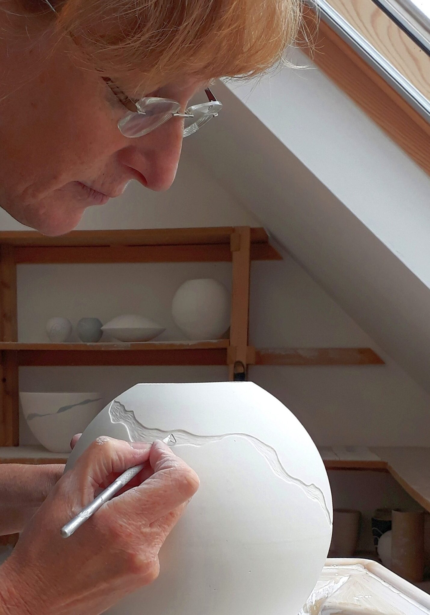 Leonie Rutter - portrait, working on porcelain vessel